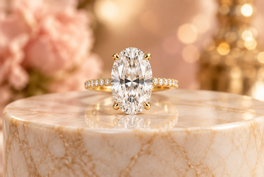 Oval moissanite solitaire ring on a marble pedestal