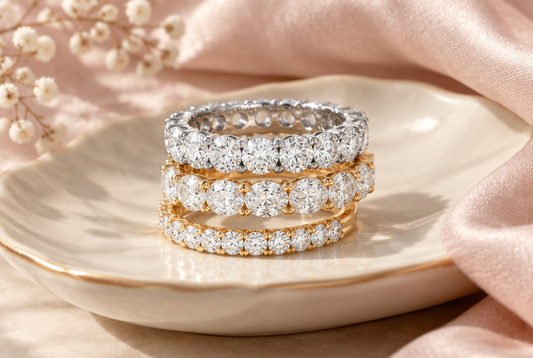 Stack of moissanite eternity bands on an ivory dish