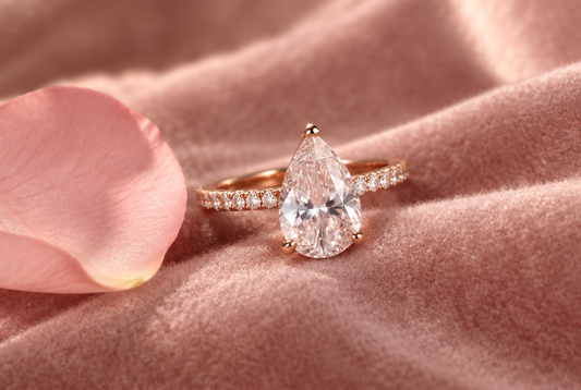 Pear shaped moissanite ring in rose gold on blush velvet