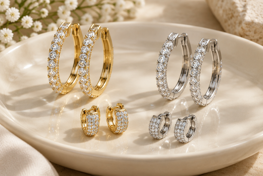 Moissanite hoop and huggie earrings on a cream dish