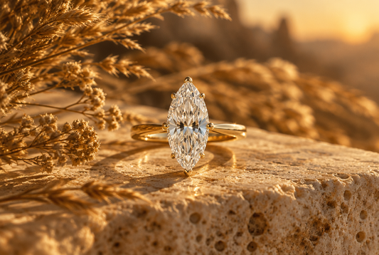 Marquise cut moissanite ring in yellow gold on travertine