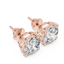 Round moissanite stud earrings in rose 925 sterling silver, four-prong basket, angled view