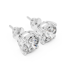 Round moissanite stud earrings in 925 sterling silver with white plating, four-prong basket, angled view