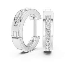 Moissanite channel set huggie earrings in white 925 sterling silver, view 1